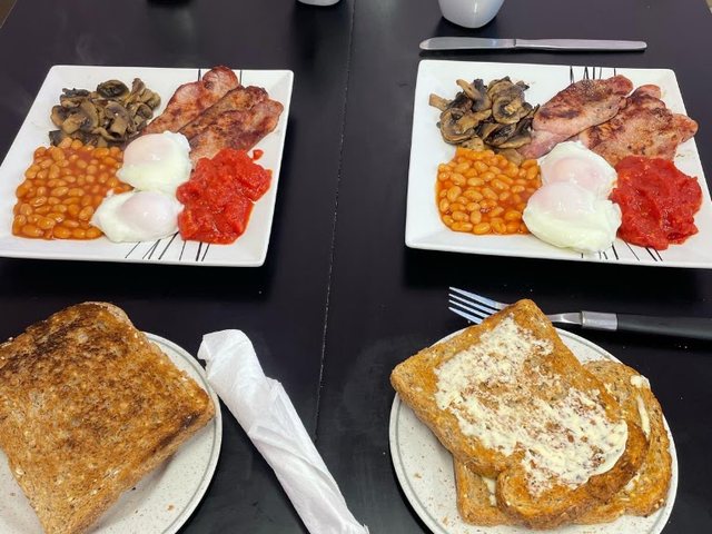 Two freshly cooked breakfasts with toast and hot drinks at Laura's Little Cafe